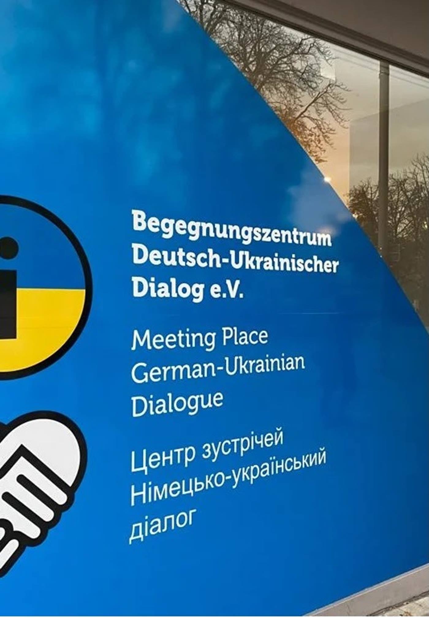 Sign of the meeting center of the association Deutsch-Ukrainischer Dialog e.V. at Königsplatz in Augsburg.