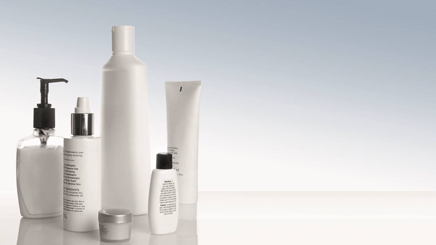 Personal care products stand on a white table: Robots can assist in the production of personal care products. 