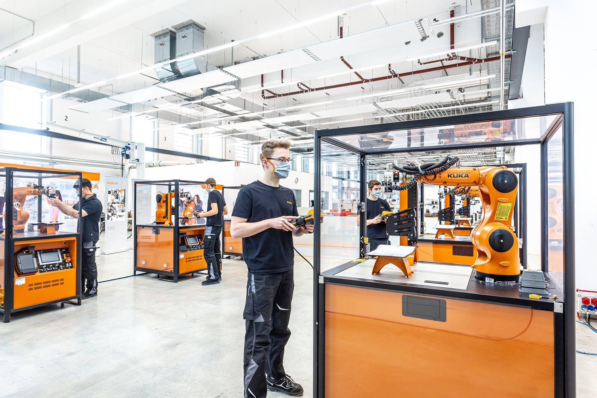 Trainees at the KUKA Training Center in Augsburg program robot cells.