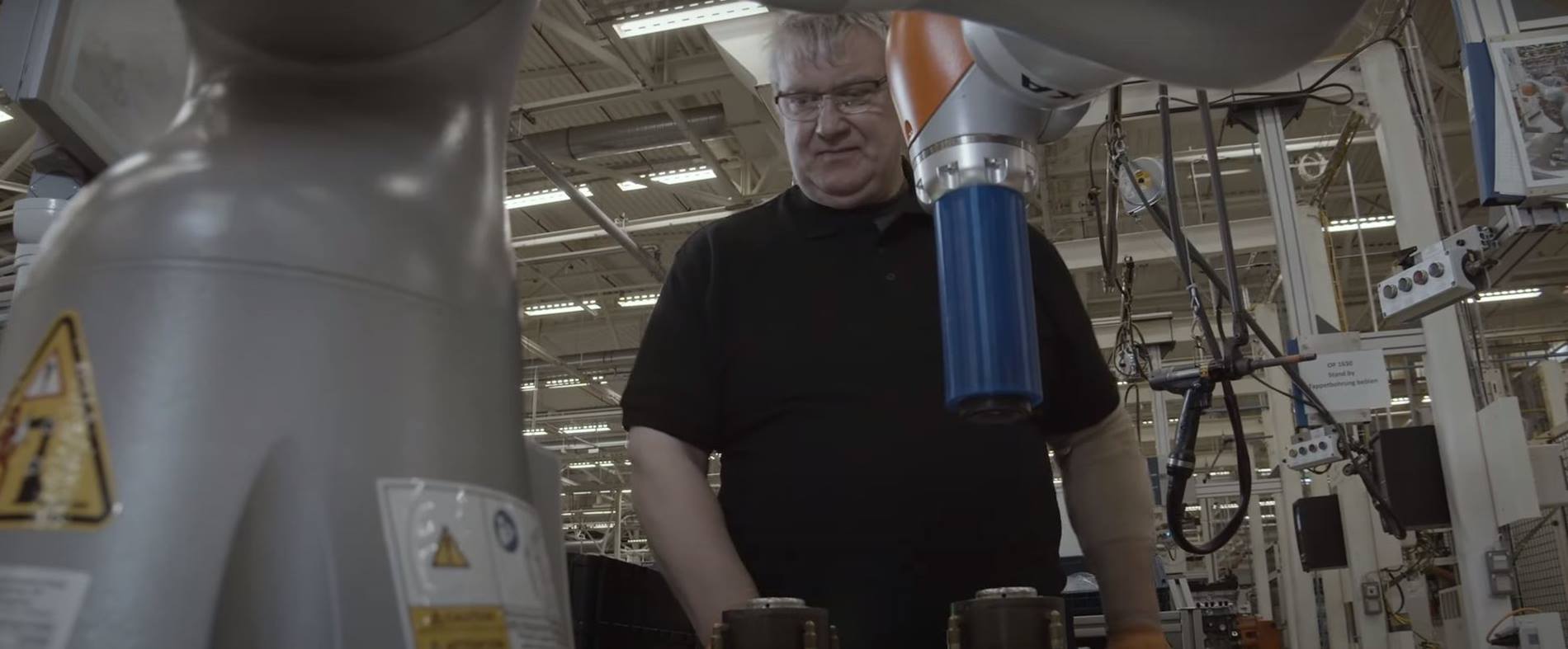 KUKA cobot supports a man in production