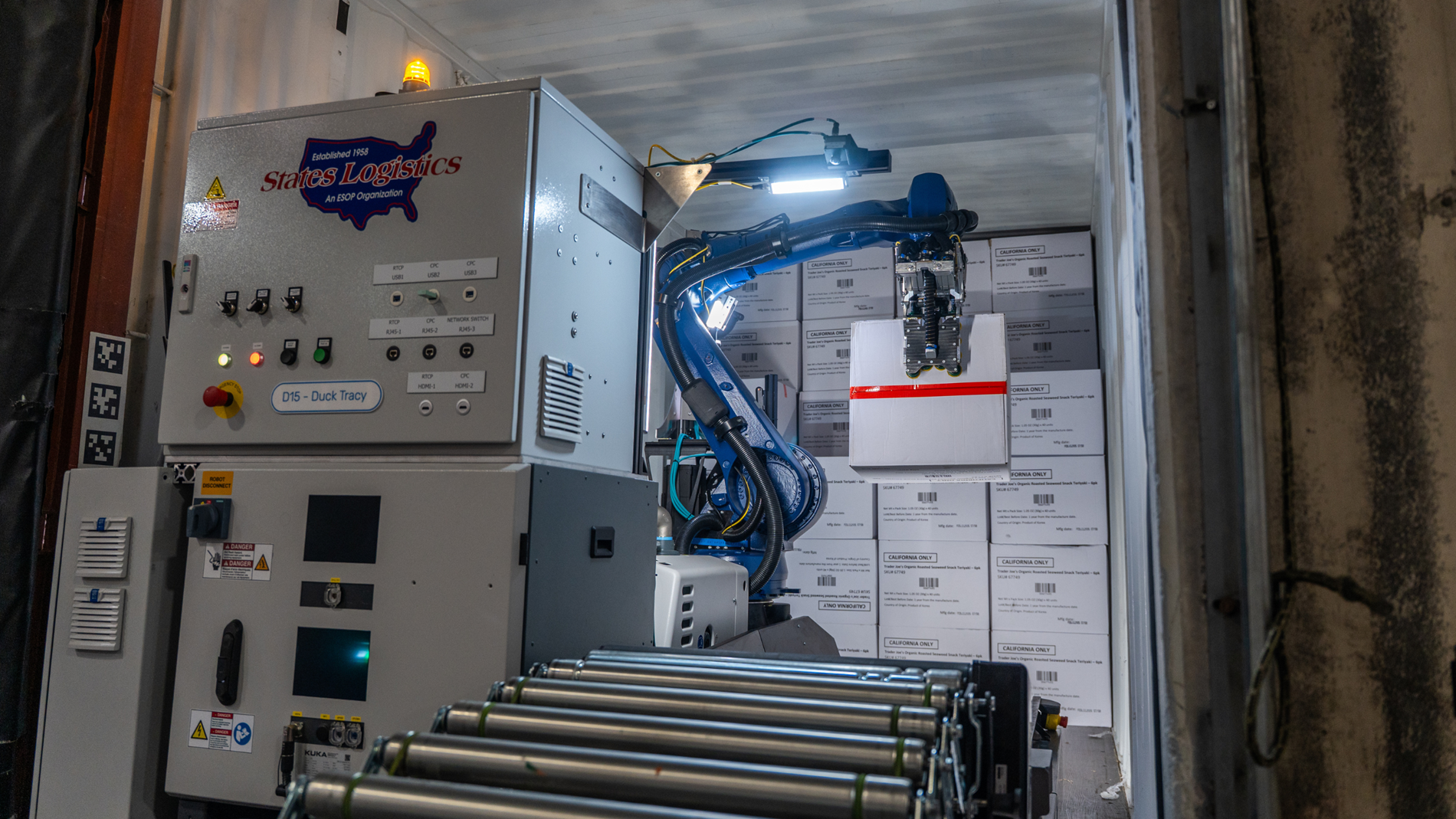 KR IONTEC robot unloads cases from a trailer onto a conveyer