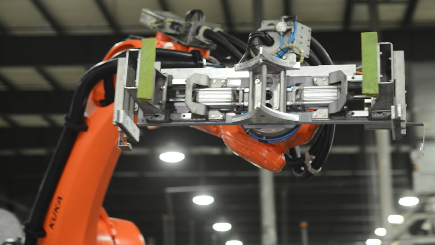 KUKA Robot with keg-handling end-of-arm tooling